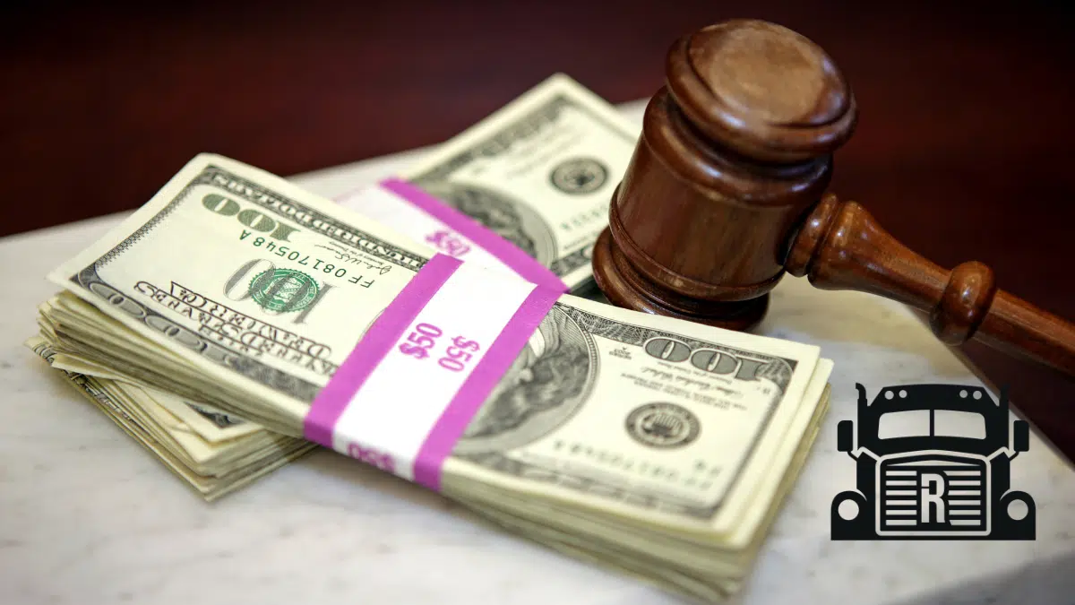 cash from a settlement next to a gavel