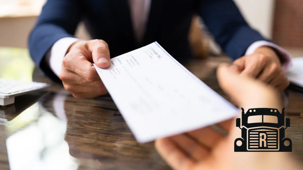 lawyer handing a compensation check to a client
