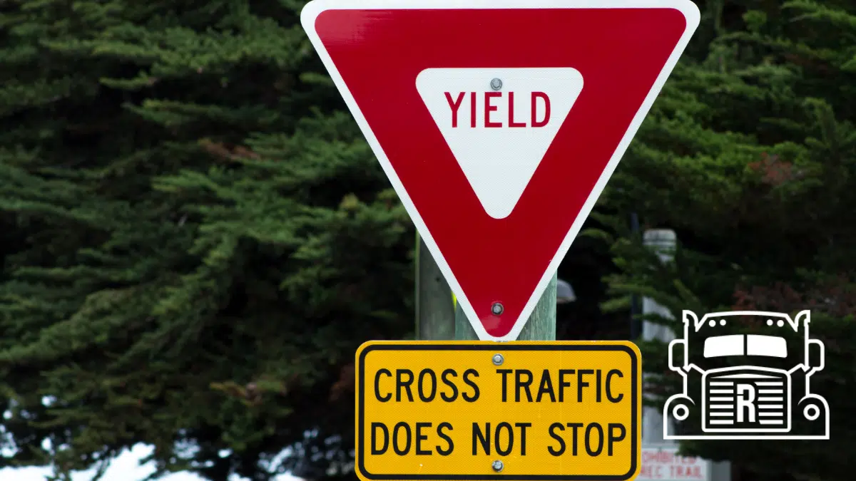 traffic sign reading "yield" and "cross traffic does not stop"