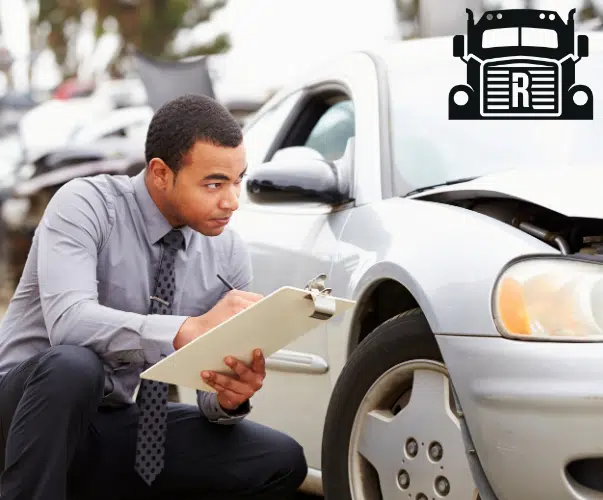 insurance adjuster looking at damages on a car