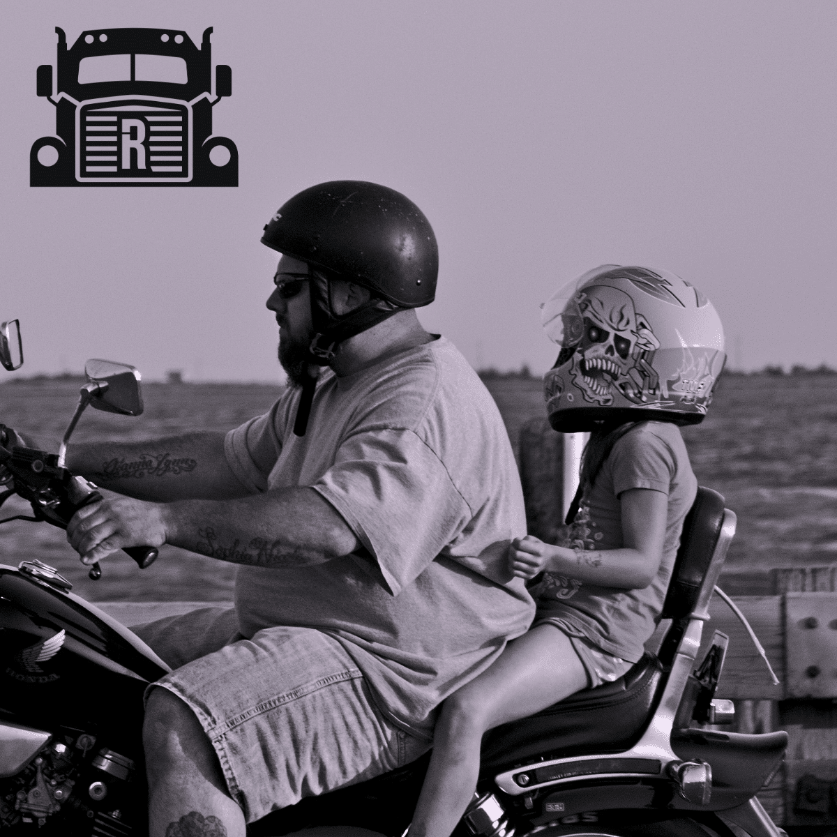 A father and daughter riding a motorcycle in the desert