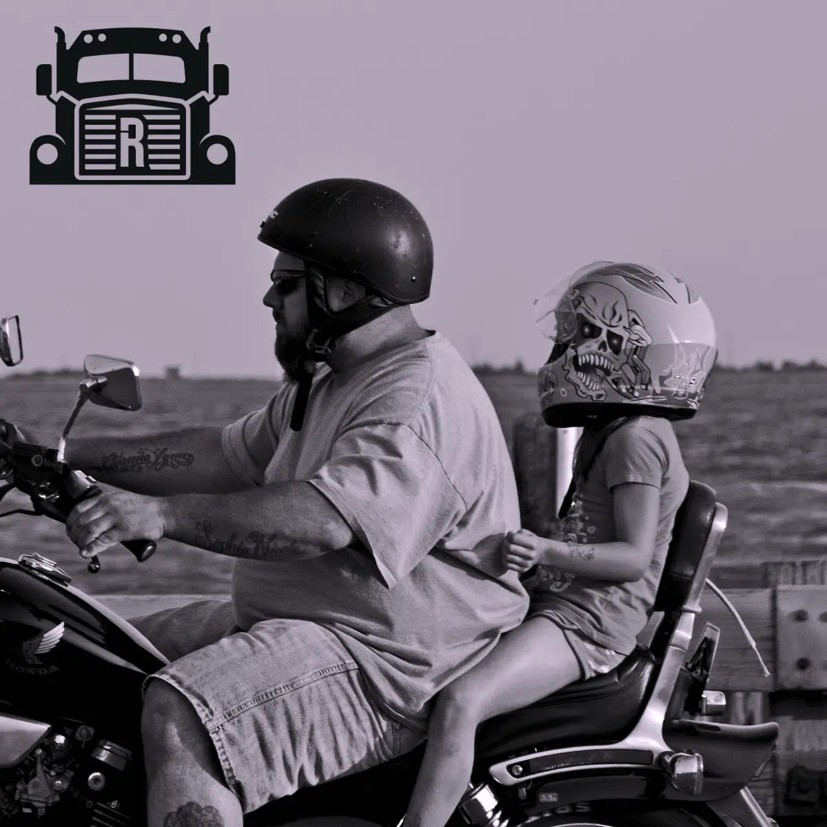 A father and daughter riding a motorcycle in the desert