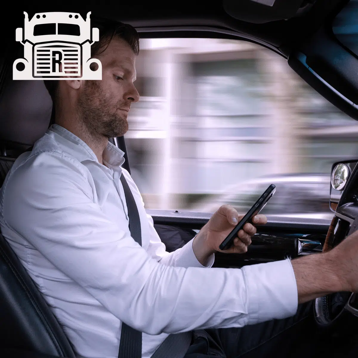A man texting while driving a car very fast.