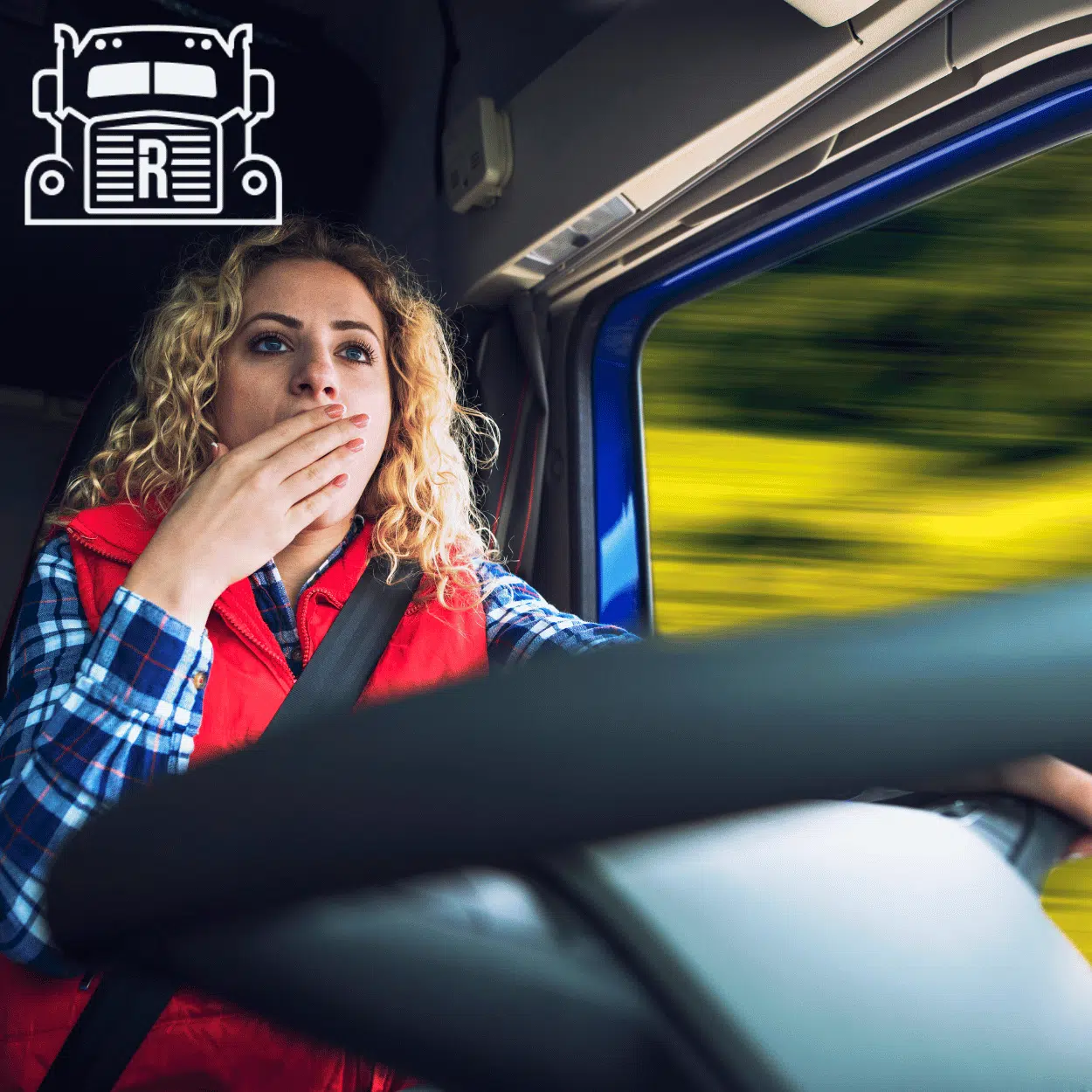 A tired female truck driver yawning