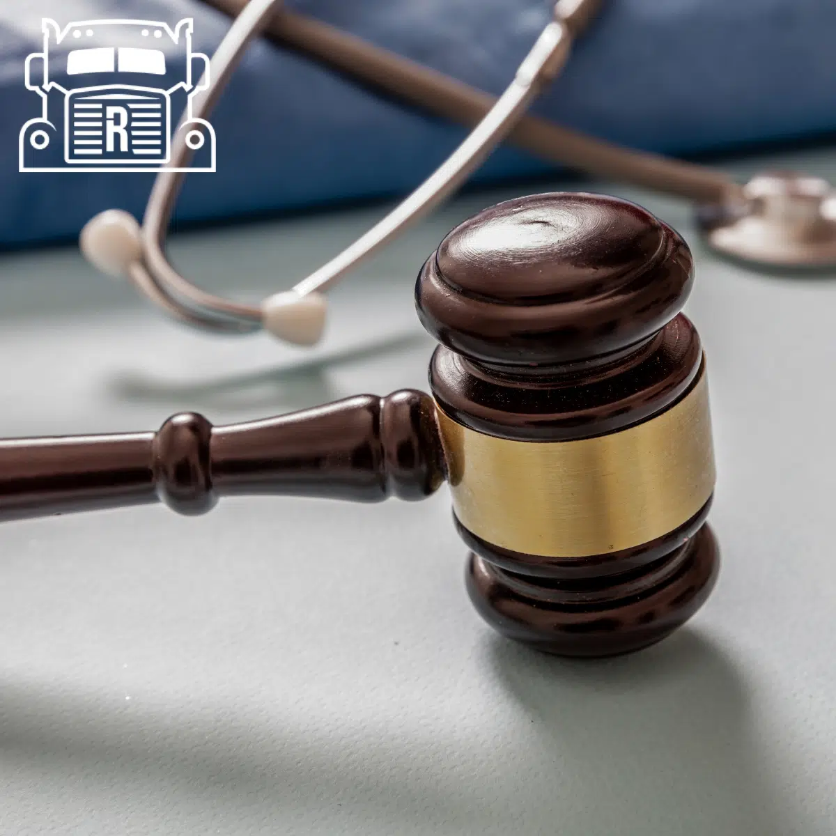 A gavel placed next to scrubs and a stethoscope