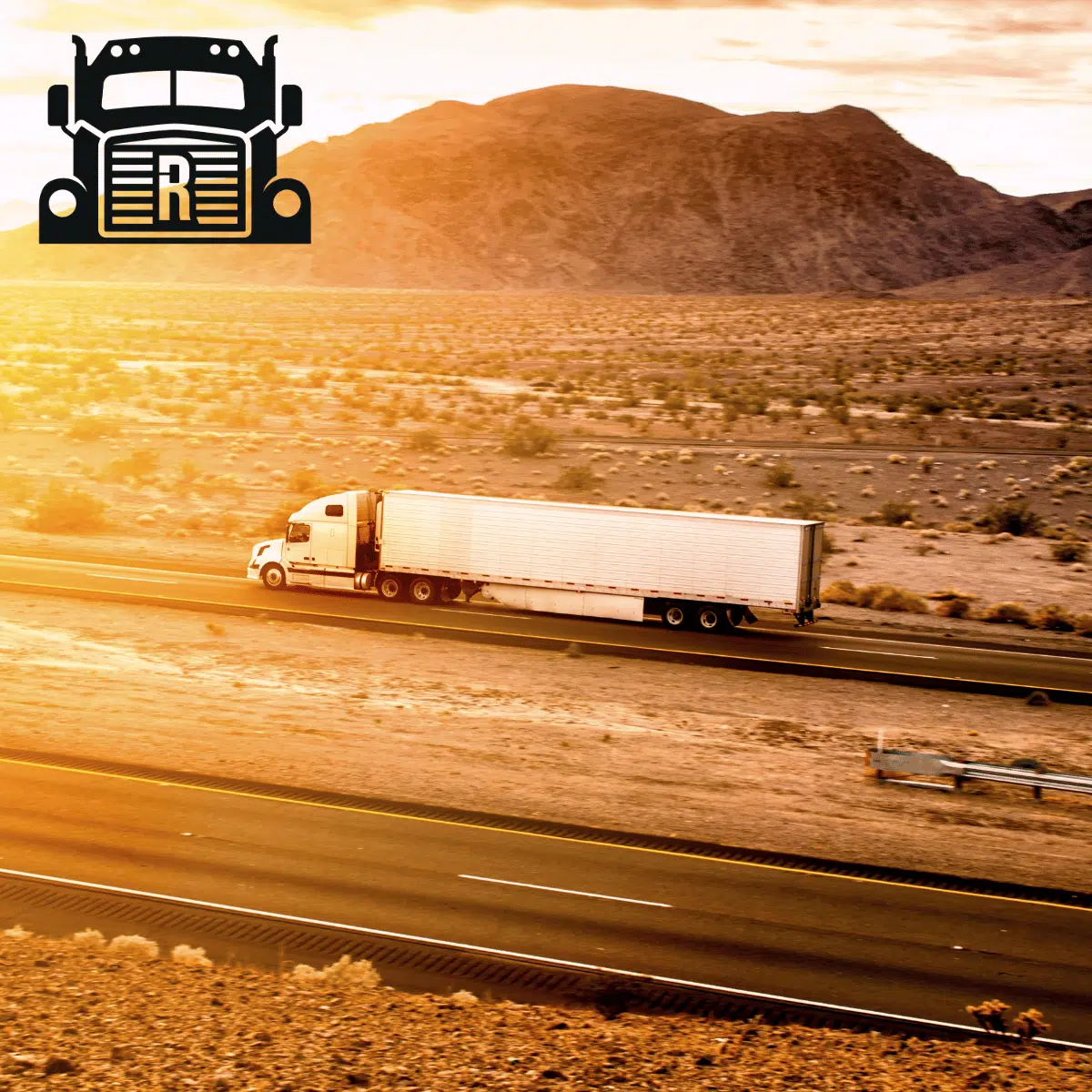 White semi-truck driving in the desert at dawn.