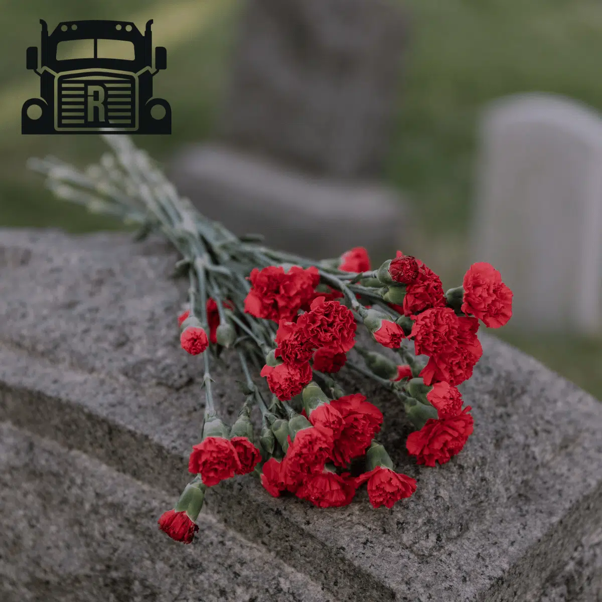 Flowers laying on a gravestone.