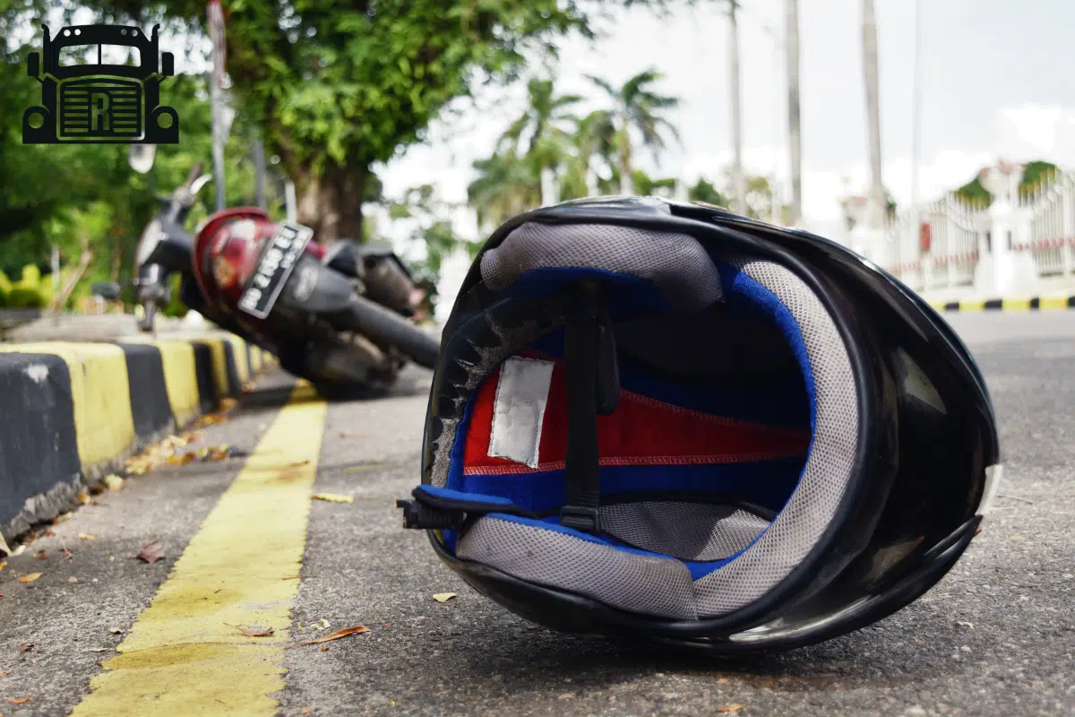 motorcycle and motorcycle helmet lying on the street