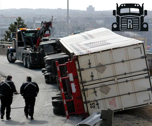 Commercial truck lying on its side after an accident
