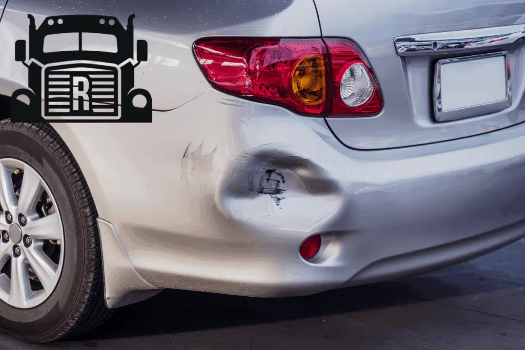 car with a dent in rear bumper