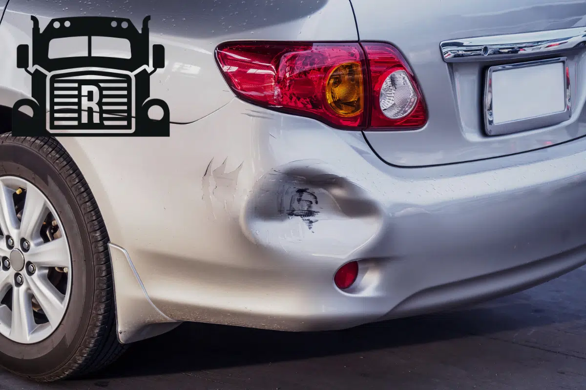 car with a dent in rear bumper